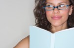 Young Woman Looking Away from Book