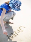 Woman Writing in the Sand