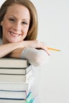 Smiling Woman with Stack of Books