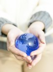 Woman Holding Small Globe