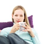 Young Woman Sitting and Holding a Cup of Coffee